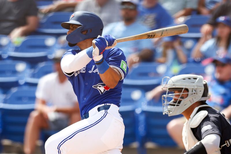 Mar 12, 2024; Dunedin, Florida, USA;  Toronto Blue Jays second baseman Santiago Espinal (5) hits a two rbi double against the New York Yankees in the fifth inning at TD Ballpark. Mandatory Credit: Nathan Ray Seebeck-USA TODAY Sports