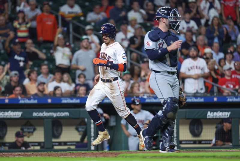 May 1, 2024; Houston, Texas, USA;  Houston Astros center fielder Mauricio Dubon (14) scores a run during the sixth inning against the Cleveland Guardians at Minute Maid Park. Mandatory Credit: Troy Taormina-USA TODAY Sports