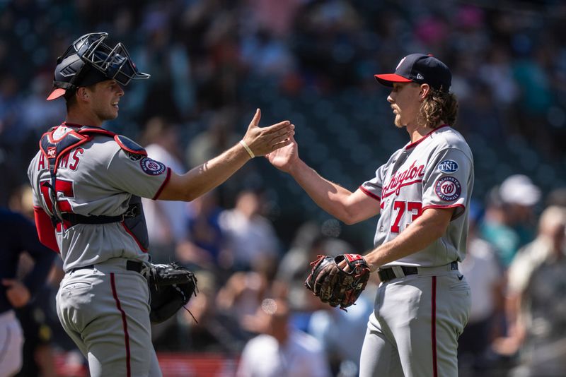 Jun 28, 2023; Seattle, Washington, USA; Washington Nationals relief pitcher Hunter Harvey (73) and catcher Riley Adams (15) celebrate after a game against the Seattle Mariners at T-Mobile Park. Mandatory Credit: Stephen Brashear-USA TODAY Sports