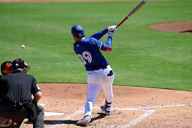 Mar 19, 2024; Dunedin, Florida, USA; Toronto Blue Jays centerfielder Kevin Kiermaier (39) hits a RBI single in the second inning of the spring training game against the Baltimore Orioles at TD Ballpark. Mandatory Credit: Jonathan Dyer-USA TODAY Sports