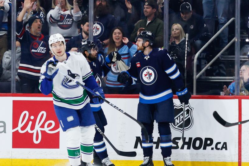 Apr 18, 2024; Winnipeg, Manitoba, CAN;  Winnipeg Jets forward Gabriel Vilardi (13) is congratulated by his team mates on his goal against Vancouver Canucks goalie Thatcher Demko (not pictured) during the first period at Canada Life Centre. Mandatory Credit: Terrence Lee-USA TODAY Sports