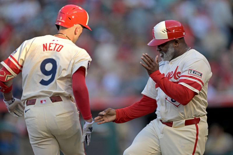 Jun 5, 2024; Anaheim, California, USA;  Los Angeles Angels shortstop Zach Neto (9) is congratulated by third base coach Eric Young Sr. (85) as he rounds the bases after hitting a two-run home run in the second inning against the San Diego Padres at Angel Stadium. Mandatory Credit: Jayne Kamin-Oncea-USA TODAY Sports