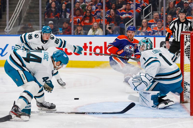 Apr 15, 2024; Edmonton, Alberta, CAN; A pass by Edmonton Oilers forward Connor McDavid (97) deflects off San Jose Sharks defensemen Marc-Edouard Vlasic (44) and goes past goaltender Devin Cooley (1) during the first period at Rogers Place. Mandatory Credit: Perry Nelson-USA TODAY Sports