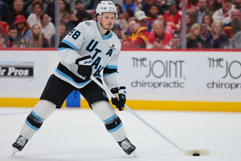 Jan 27, 2026; Sunrise, Florida, USA; Utah Mammoth defenseman Mikhail Sergachev (98) moves the puck against the Florida Panthers during the second period at Amerant Bank Arena. Mandatory Credit: Sam Navarro-Imagn Images