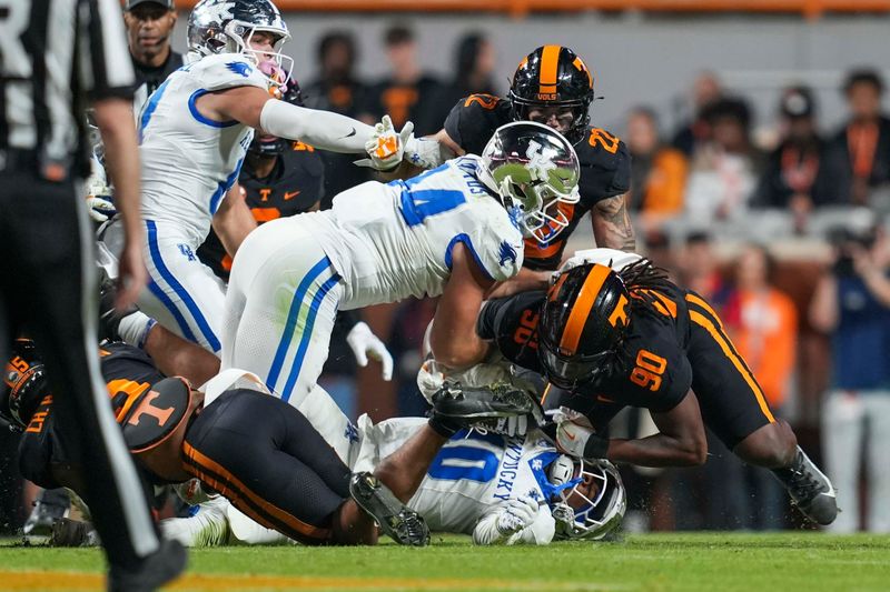 Nov 2, 2024; Knoxville, Tennessee, USA; Tennessee Volunteers defensive lineman Dominic Bailey (90) tackles Kentucky Wildcats running back Jamarion Wilcox (10) during the first half at Neyland Stadium. Mandatory Credit: Angelina Alcantar/USA TODAY Network via Imagn Images
