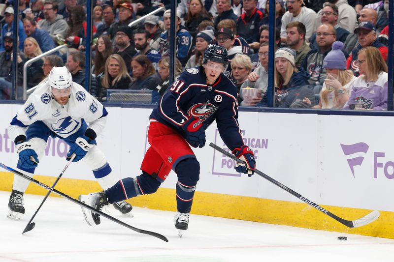 Nov 21, 2024; Columbus, Ohio, USA; Columbus Blue Jackets center Kent Johnson (91) looks to pass as Tampa Bay Lightning defenseman Erik Cernak (81) trails the play during the second period at Nationwide Arena. Mandatory Credit: Russell LaBounty-Imagn Images