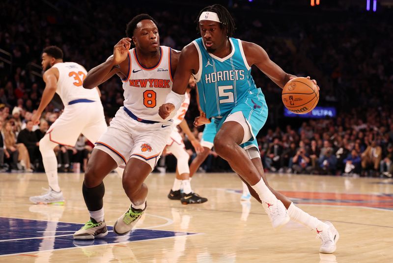 NEW YORK, NEW YORK - DECEMBER 05:  Mark Williams #5 of the Charlotte Hornets drives against OG Anunoby #8 of the New York Knicks during their game at Madison Square Garden on December 05, 2024 in New York City.  User expressly acknowledges and agrees that, by downloading and or using this photograph, User is consenting to the terms and conditions of the Getty Images License Agreement.  (Photo by Al Bello/Getty Images)