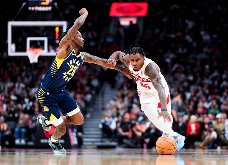 TORONTO, ON - NOVEMBER 18: Davion Mitchell #45 of the Toronto Raptors drives against Quenton Jackson #29 of the Indiana Pacers during the second half of their basketball game at the Scotiabank Arena on November 18, 2024 in Toronto, Ontario, Canada. NOTE TO USER: User expressly acknowledges and agrees that, by downloading and/or using this Photograph, user is consenting to the terms and conditions of the Getty Images License Agreement. (Photo by Mark Blinch/Getty Images)