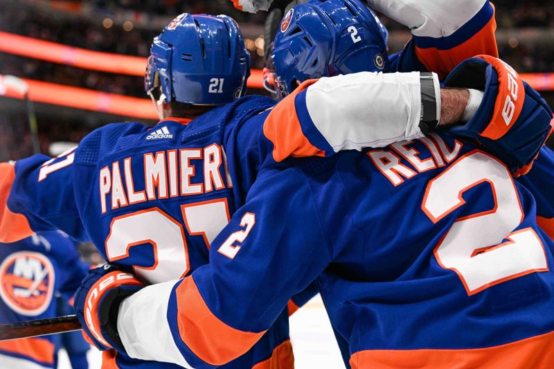 Apr 11, 2024; Elmont, New York, USA; New York Islanders defenseman Mike Reilly (2) celebrates the game winning goal by New York Islanders center Kyle Palmieri (21) against the Montreal Canadiens during the overtime at UBS Arena. Mandatory Credit: Dennis Schneidler-USA TODAY Sports