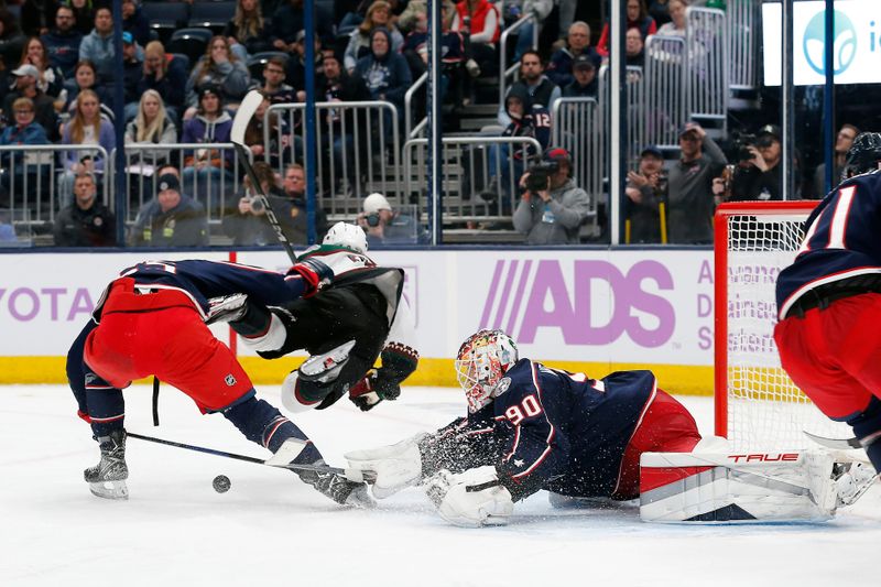 Nov 16, 2023; Columbus, Ohio, USA; Arizona Coyotes center Clayton Keller (9) falls to the ice after colliding with Columbus Blue Jackets defenseman David Jiricek (55) during the third period at Nationwide Arena. Mandatory Credit: Russell LaBounty-USA TODAY Sports