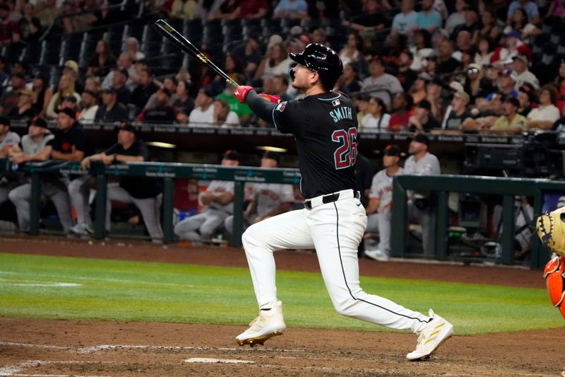 Jun 3, 2024; Phoenix, Arizona, USA; Arizona Diamondbacks outfielder Pavin Smith (26) hits a two run home run against the San Francisco Giants in the ninth inning at Chase Field. Mandatory Credit: Rick Scuteri-USA TODAY Sports