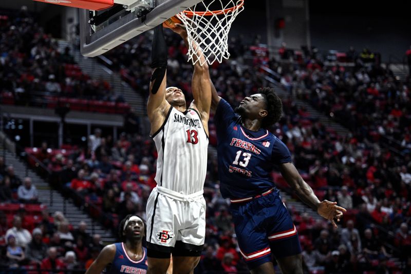 Jan 3, 2024; San Diego, California, USA; San Diego State Aztecs forward Jaedon LeDee (13) is fouled by Fresno State Bulldogs center Enoch Boakye (13) during the second half at Viejas Arena. Mandatory Credit: Orlando Ramirez-USA TODAY Sports 