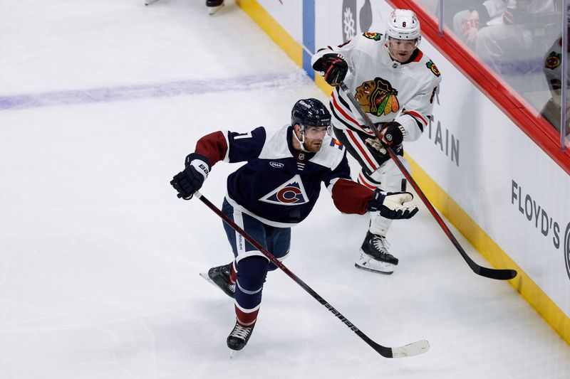 Oct 28, 2024; Denver, Colorado, USA; Colorado Avalanche center Parker Kelly (17) grabs a loose puck ahead of Chicago Blackhawks center Ryan Donato (8) in the second period at Ball Arena. Mandatory Credit: Isaiah J. Downing-Imagn Images