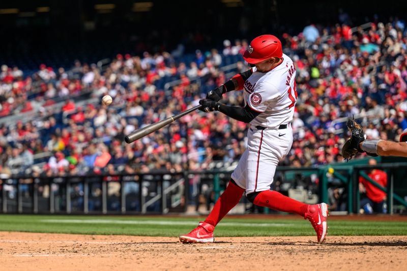 Apr 7, 2024; Washington, District of Columbia, USA; Washington Nationals shortstop Ildemaro Vargas (14) hits a single during the eighth inning against the Philadelphia Phillies at Nationals Park. Mandatory Credit: Reggie Hildred-USA TODAY Sports