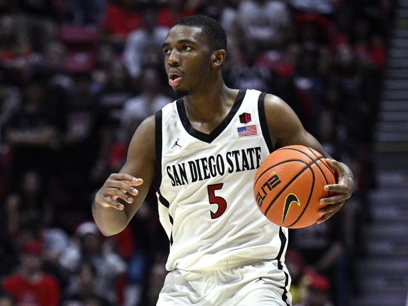 Nov 6, 2023; San Diego, California, USA; San Diego State Aztecs guard Lamont Butler (5) dribbles the ball during the second half against the Cal State Fullerton Titans at Viejas Arena. Mandatory Credit: Orlando Ramirez-USA TODAY Sports