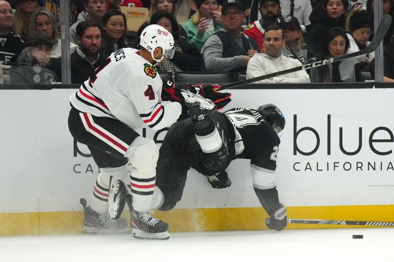 Nov 2, 2024; Los Angeles, California, USA; Chicago Blackhawks defenseman Seth Jones (4) and LA Kings center Phillip Danault (24) battle for the puck in the second period at Crypto.com Arena. Mandatory Credit: Kirby Lee-Imagn Images