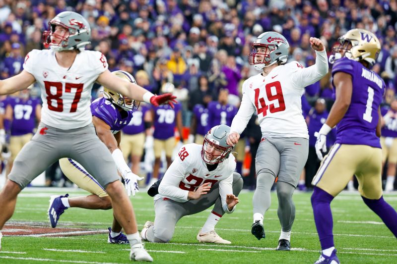 Nov 25, 2023; Seattle, Washington, USA; Washington State Cougars place kicker Dean Janikowski (49) makes an extra point against the Washington Huskies during the fourth quarter at Alaska Airlines Field at Husky Stadium. Mandatory Credit: Joe Nicholson-USA TODAY Sports