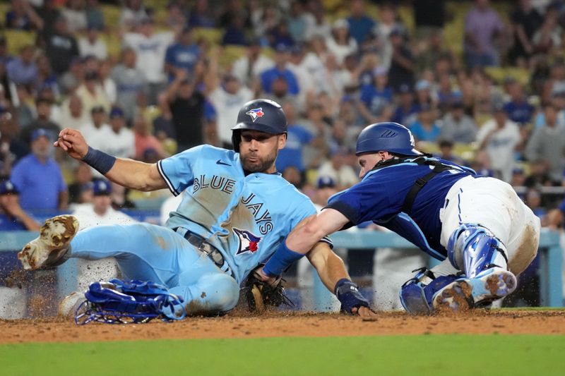 Jul 25, 2023; Los Angeles, California, USA; Los Angeles Dodgers catcher Will Smith (16) tags out Toronto Blue Jays center fielder Kevin Kiermaier (39) out at home plate in the 10th inning at Dodger Stadium. Mandatory Credit: Kirby Lee-USA TODAY Sports