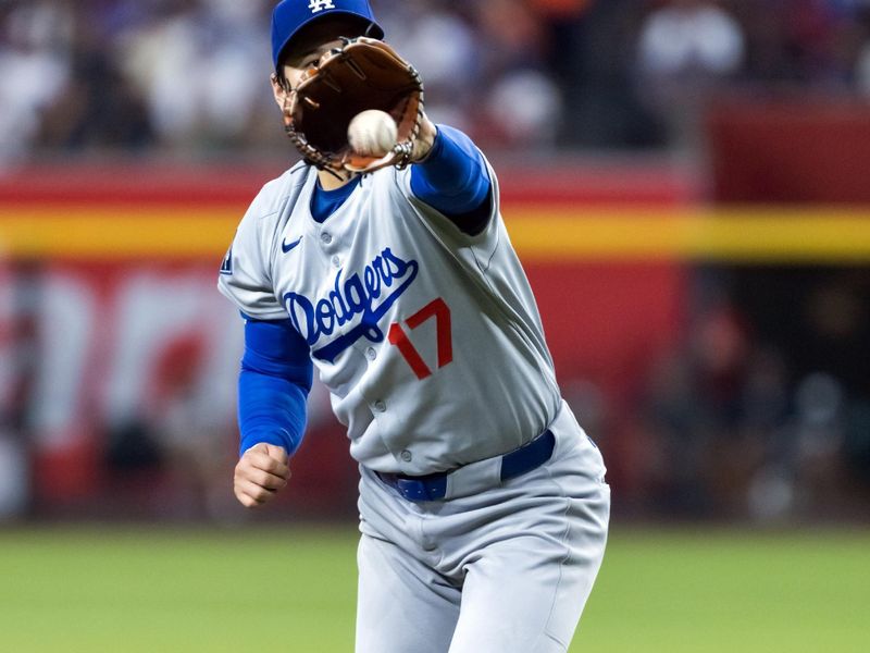 Sep 23, 2025; Phoenix, Arizona, USA; Los Angeles Dodgers pitcher Shohei Ohtani fields a line drive to start a double play in the fifth inning against the Arizona Diamondbacks at Chase Field. Mandatory Credit: Mark J. Rebilas-Imagn Images