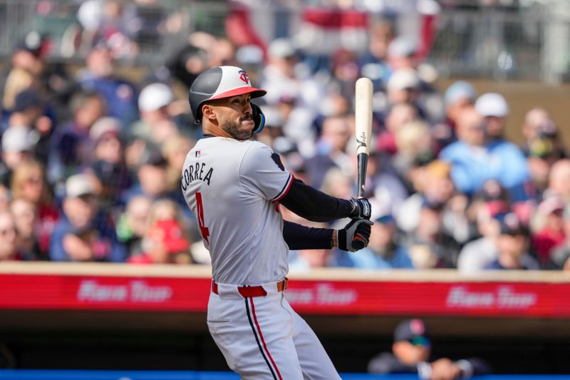 Apr 4, 2024; Minneapolis, Minnesota, USA; Minnesota Twins shortstop Carlos Correa (4) hits a single during the second inning against the Cleveland Guardians at Target Field. Mandatory Credit: Jordan Johnson-USA TODAY Sports