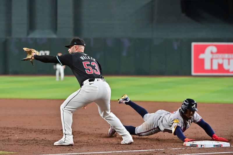 Jul 10, 2024; Phoenix, Arizona, USA;  Atlanta Braves second baseman Ozzie Albies (1) tags up as Arizona Diamondbacks first baseman Christian Walker (53) waits for the pickoff throw in the third inning at Chase Field. Mandatory Credit: Matt Kartozian-USA TODAY Sports