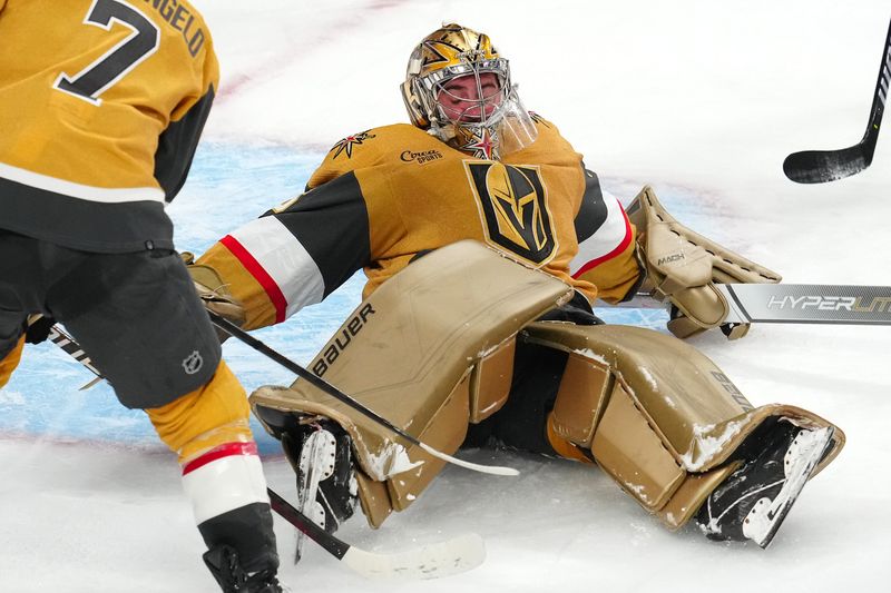 Nov 25, 2023; Las Vegas, Nevada, USA; Vegas Golden Knights goaltender Logan Thompson (36) lays down to cover the puck after making a save against the Arizona Coyotes during the third period at T-Mobile Arena. Mandatory Credit: Stephen R. Sylvanie-USA TODAY Sports