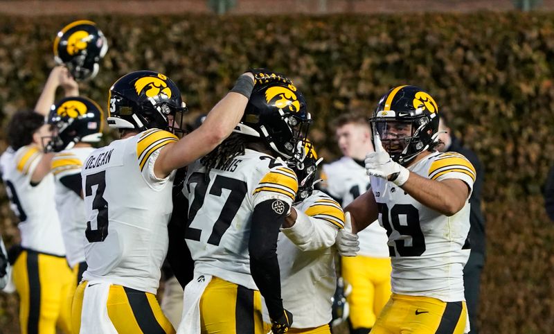 Nov 4, 2023; Chicago, Illinois, USA; The Iowa Hawkeyes celebrate their win against the Northwestern Wildcats at Wrigley Field. Mandatory Credit: David Banks-USA TODAY Sports