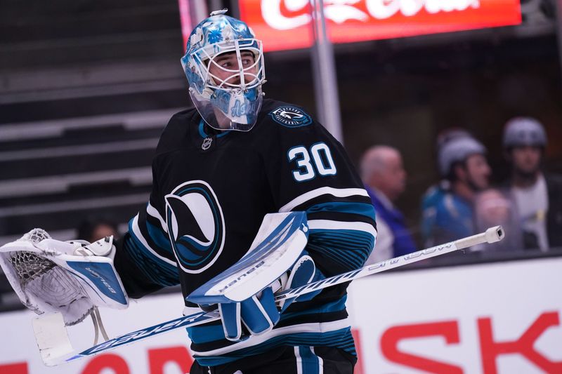 Oct 28, 2025; San Jose, California, USA; San Jose Sharks goaltender Yaroslav Askarov (30) waits for play to resume against the Los Angeles Kings in the first period at SAP Center at San Jose. Mandatory Credit: David Gonzales-Imagn Images