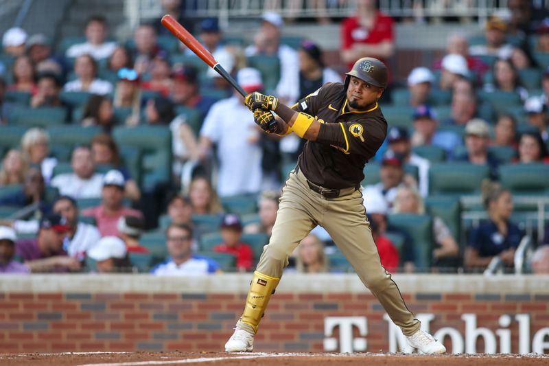 May 19, 2024; Atlanta, Georgia, USA; San Diego Padres second baseman Luis Arraez (4) hits a single against the Atlanta Braves in the second inning at Truist Park. Mandatory Credit: Brett Davis-USA TODAY Sports