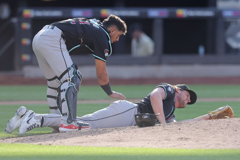 Jun 1, 2024; New York City, New York, USA; Arizona Diamondbacks relief pitcher Kevin Ginkel (37) reacts as catcher Gabriel Moreno (14) checks on him after he was hit by a comebacker by New York Mets left fielder Brandon Nimmo (not pictured) during the sixth inning at Citi Field. Mandatory Credit: Brad Penner-USA TODAY Sports