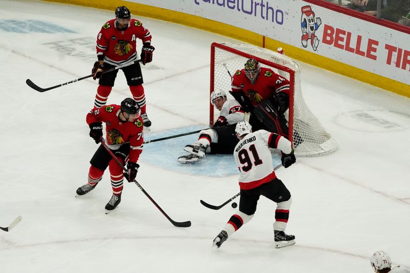 Feb 17, 2024; Chicago, Illinois, USA; Ottawa Senators right wing Vladimir Tarasenko (91) shoots the puck with center Shane Pinto (57) in the net as Chicago Blackhawks goalie Petr Mrazek (34) defends during the first period at United Center. Mandatory Credit: David Banks-USA TODAY Sports
