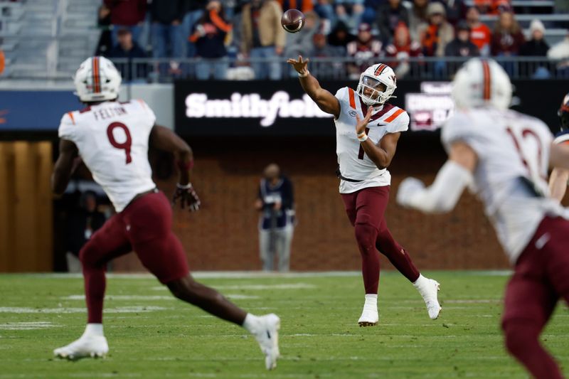 Nov 25, 2023; Charlottesville, Virginia, USA; Virginia Tech Hokies quarterback Kyron Drones (1) passes the ball to Hokies wide receiver Da'Quan Felton (9) against the Virginia Cavaliers during the second quarter at Scott Stadium. Mandatory Credit: Geoff Burke-USA TODAY Sports