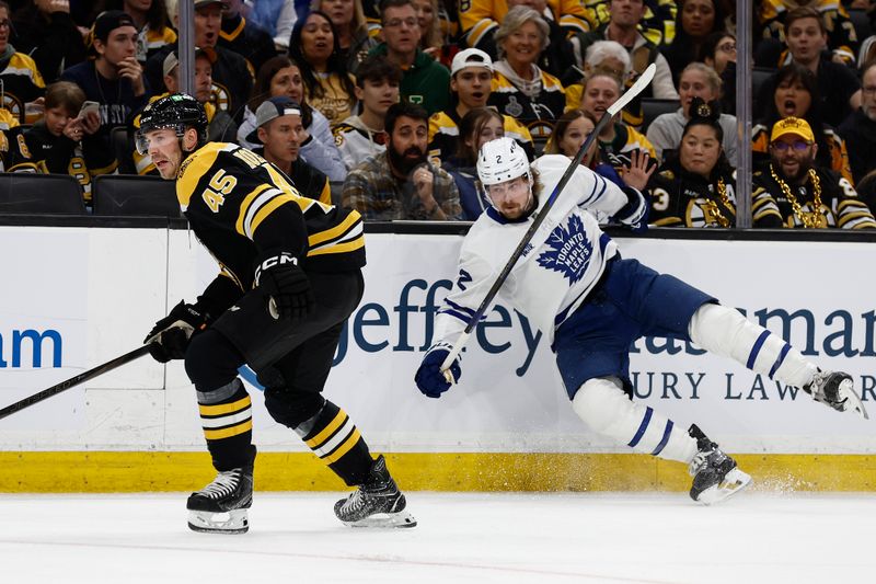 Oct 26, 2024; Boston, Massachusetts, USA; Toronto Maple Leafs defenseman Simon Benoit (2) hits the boards after missing a check on Boston Bruins left wing Cole Koepke (45) during the first period at TD Garden. Mandatory Credit: Winslow Townson-Imagn Images