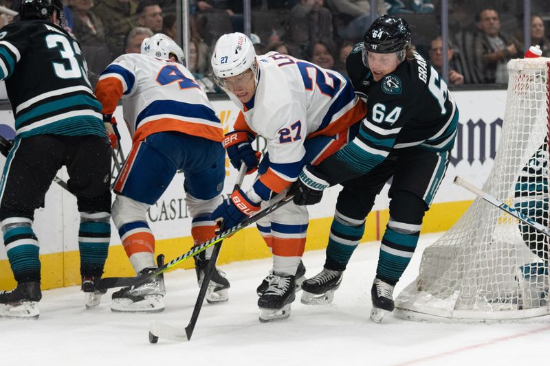 Mar 7, 2024; San Jose, California, USA; New York Islanders left wing Anders Lee (27) and San Jose Sharks center Mikael Granlund (64) fight for control of the puck during the first period at SAP Center at San Jose. Mandatory Credit: Stan Szeto-USA TODAY Sports