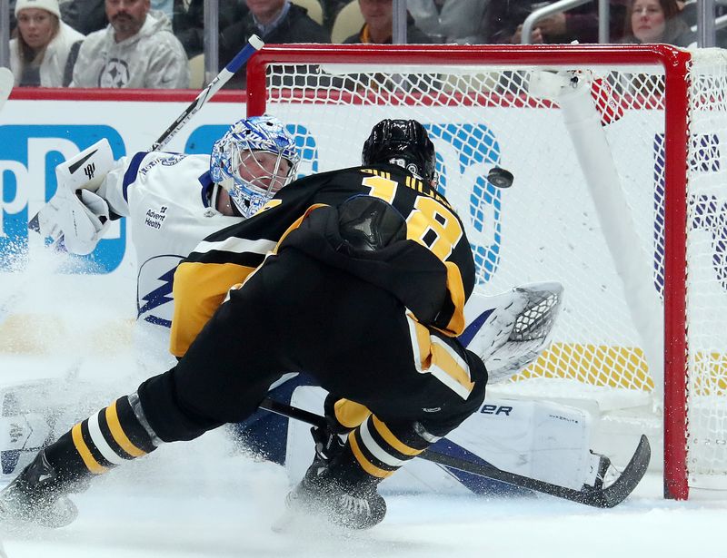 Nov 19, 2024; Pittsburgh, Pennsylvania, USA;  Pittsburgh Penguins right wing Jesse Puljujarvi (18) scores a goal against Tampa Bay Lightning goaltender Andrei Vasilevskiy (88) during the first period at PPG Paints Arena. Mandatory Credit: Charles LeClaire-Imagn Images