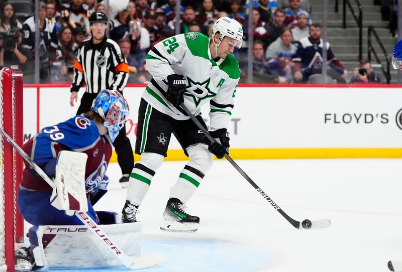 May 1, 2025; Denver, Colorado, USA; Dallas Stars center Roope Hintz (24) controls the puck in from of Colorado Avalanche goaltender Mackenzie Blackwood (39) in the third period in game six of the first round of the 2025 Stanley Cup Playoffs at Ball Arena. Mandatory Credit: Ron Chenoy-Imagn Images