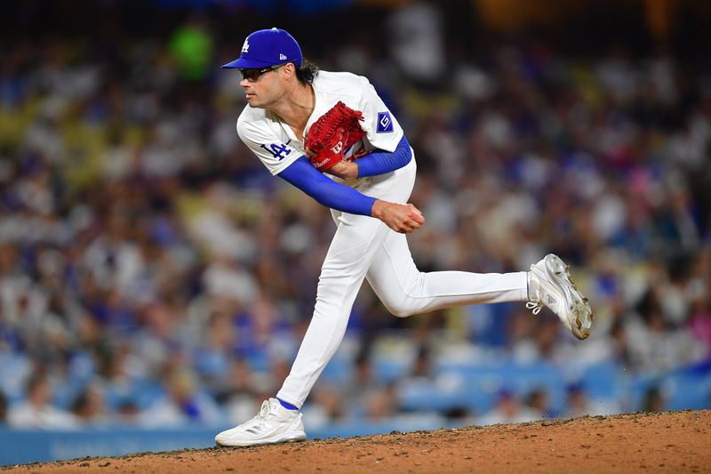 Aug 19, 2024; Los Angeles, California, USA; Los Angeles Dodgers pitcher Joe Kelly (99) throws against the Seattle Mariners during the eighth inning at Dodger Stadium. Mandatory Credit: Gary A. Vasquez-USA TODAY Sports