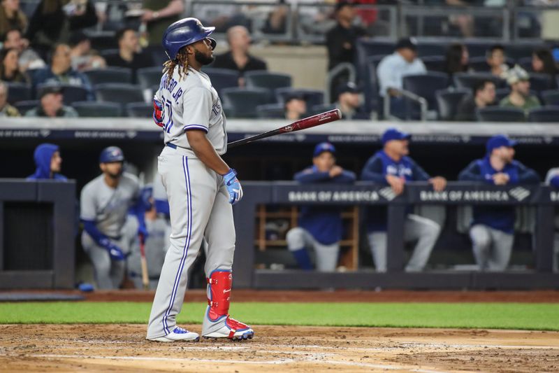 Apr 13, 2022; Bronx, New York, USA;  Toronto Blue Jays first baseman Vladimir Guerrero Jr. (27) hits a two run home run in the third inning against the New York Yankees at Yankee Stadium. Mandatory Credit: Wendell Cruz-USA TODAY Sports