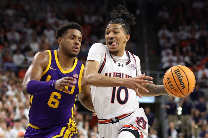 Jan 13, 2024; Auburn, Alabama, USA; Auburn Tigers guards Chad Baker-Mazara (10) moves past LSU Tigers guard Jordan Wright (6) for a shot during the second half at Neville Arena. Mandatory Credit: John Reed-USA TODAY Sports