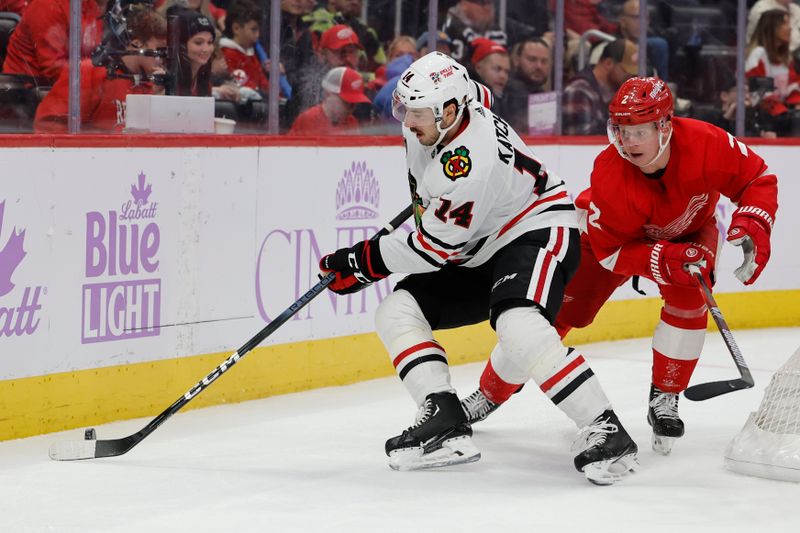 Nov 30, 2023; Detroit, Michigan, USA; Chicago Blackhawks left wing Boris Katchouk (14) skates with the puck chased by Detroit Red Wings defenseman Olli Maatta (2) in the second period at Little Caesars Arena. Mandatory Credit: Rick Osentoski-USA TODAY Sports