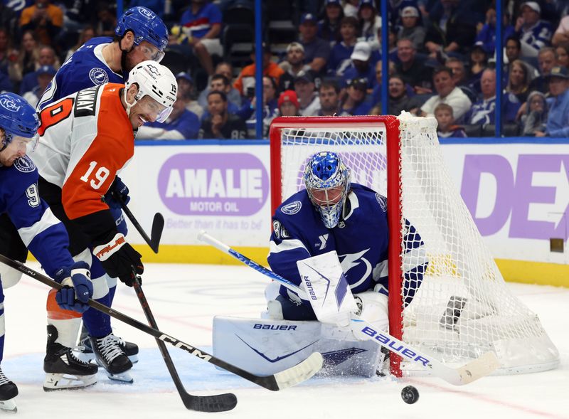 Nov 24, 2025; Tampa, Florida, USA; Tampa Bay Lightning goaltender Andrei Vasilevskiy (88) defends the puck from Philadelphia Flyers right wing Garnet Hathaway (19)  during the second period at Benchmark International Arena. Mandatory Credit: Kim Klement Neitzel-Imagn Images