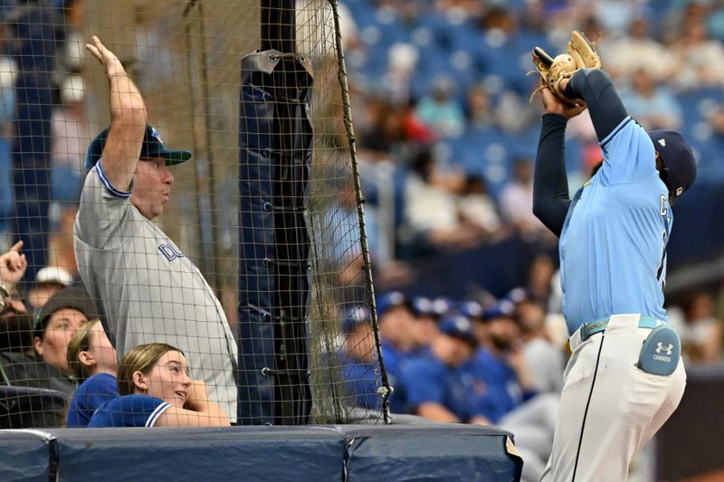 Sep 22, 2024; St. Petersburg, Florida, USA; Tampa Bay Rays third baseman Junior Caminero (13) catches a foul ball in the second inning against the Toronto Blue Jays at Tropicana Field. Mandatory Credit: Jonathan Dyer-Imagn Images