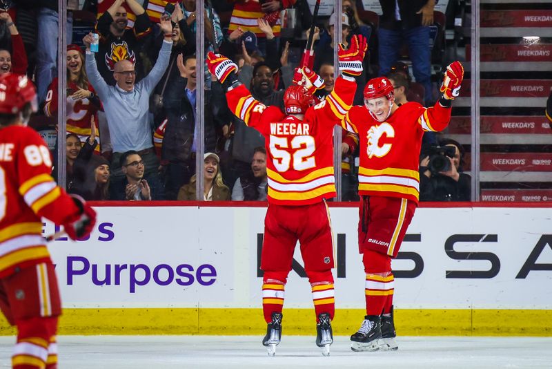 Apr 12, 2023; Calgary, Alberta, CAN; Calgary Flames defenseman Nikita Zadorov (16) celebrates his goal with teammates against the San Jose Sharks during the third period at Scotiabank Saddledome. Mandatory Credit: Sergei Belski-USA TODAY Sports