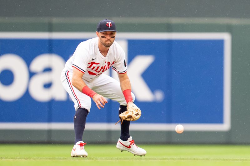Jun 7, 2025; Minneapolis, Minnesota, USA; Minnesota Twins second base Kody Clemens (18) fields a ball hit by Toronto Blue Jays third base Addison Barger (47), he would throw to first base for the out in the ninth inning at Target Field. Mandatory Credit: Matt Blewett-Imagn Images