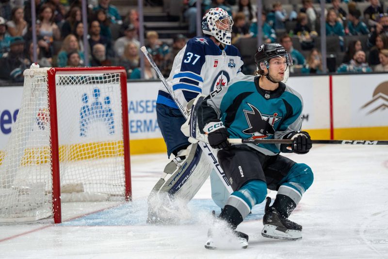 Feb 28, 2026; San Jose, California, USA; San Jose Sharks left wing William Eklund (72) positions in front of net against Winnipeg Jets goaltender Connor Hellebuyck (37) for the pass during the second period at SAP Center at San Jose. Mandatory Credit: Neville E. Guard-Imagn Images