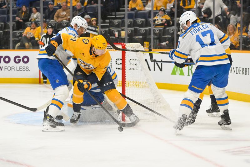 Dec 11, 2025; Nashville, Tennessee, USA;  St. Louis Blues defenseman Cam Fowler (17) and Nashville Predators left wing Reid Schaefer (49) battle for the puck during the first period at Bridgestone Arena. Mandatory Credit: Steve Roberts-Imagn Images
