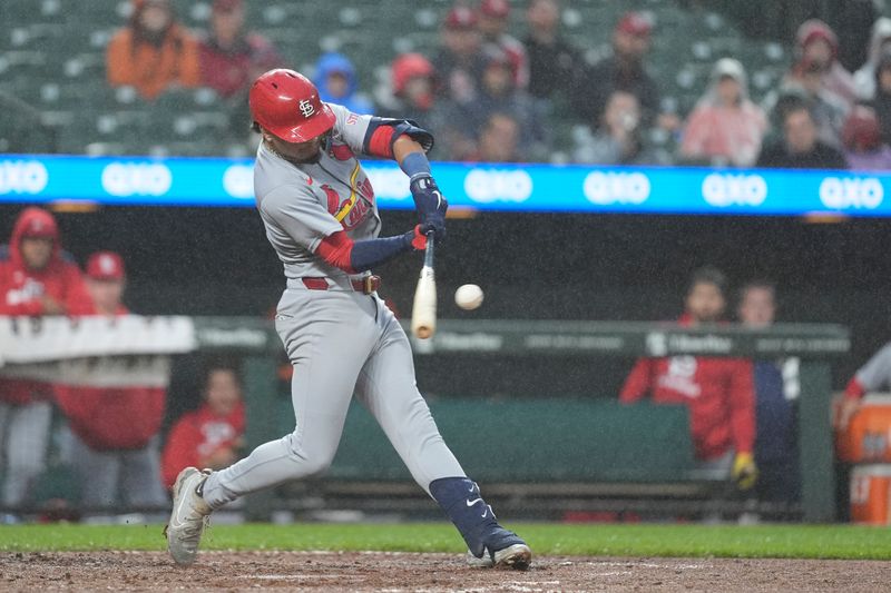 May 28, 2025; Baltimore, Maryland, USA; St. Louis Cardinals shortstop Masyn Winn (0) hits a single against the Baltimore Orioles during the fourth inning at Oriole Park at Camden Yards. Mandatory Credit: Gregory Fisher-Imagn Images