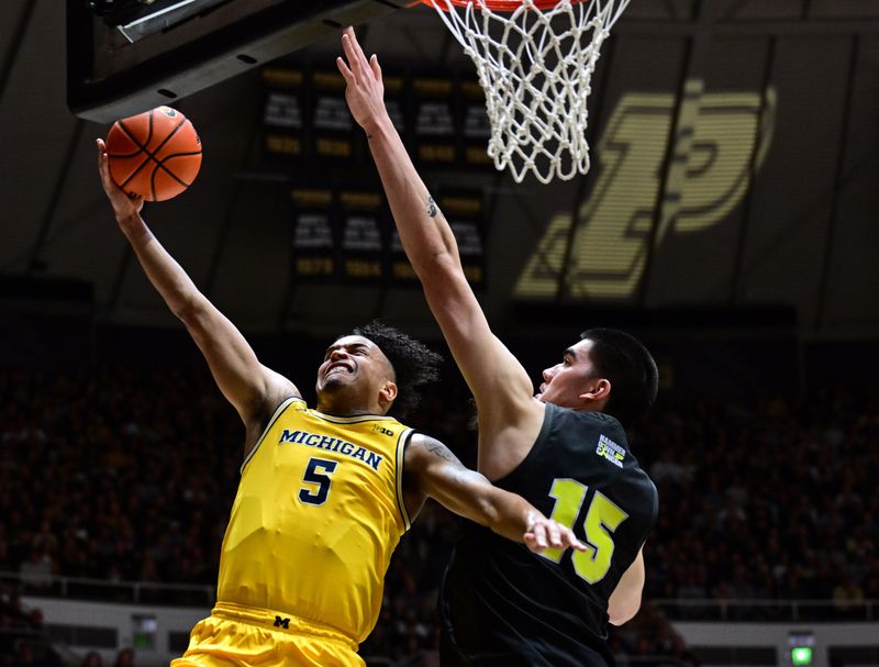 Jan 23, 2024; West Lafayette, Indiana, USA; Michigan Wolverines forward Terrance Williams II (5) shoots the ball past Purdue Boilermakers center Zach Edey (15 during the first half at Mackey Arena. Mandatory Credit: Marc Lebryk-USA TODAY Sports