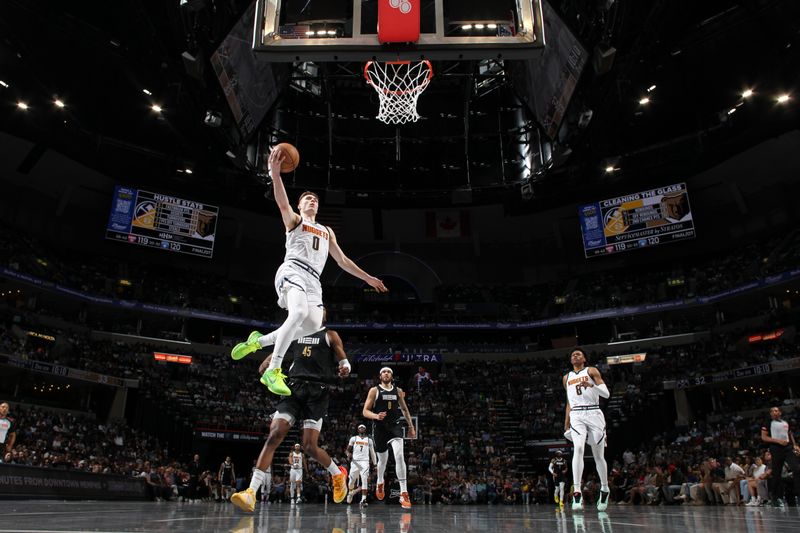 MEMPHIS, TN - APRIL 14: Christian Braun #0 of the Denver Nuggets drives to the basket during the game against the Memphis Grizzlies on April 14, 2024 at FedExForum in Memphis, Tennessee. NOTE TO USER: User expressly acknowledges and agrees that, by downloading and or using this photograph, User is consenting to the terms and conditions of the Getty Images License Agreement. Mandatory Copyright Notice: Copyright 2024 NBAE (Photo by Joe Murphy/NBAE via Getty Images)