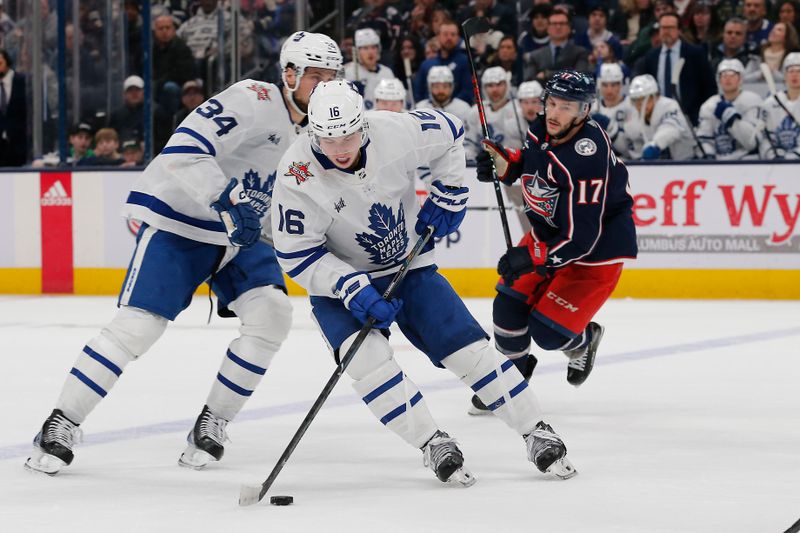 Dec 29, 2023; Columbus, Ohio, USA; Toronto Maple Leafs right wing Mitchell Marner (16) controls the puck as Columbus Blue Jackets right wing Justin Danforth (17) trails the play during overtime at Nationwide Arena. Mandatory Credit: Russell LaBounty-USA TODAY Sports